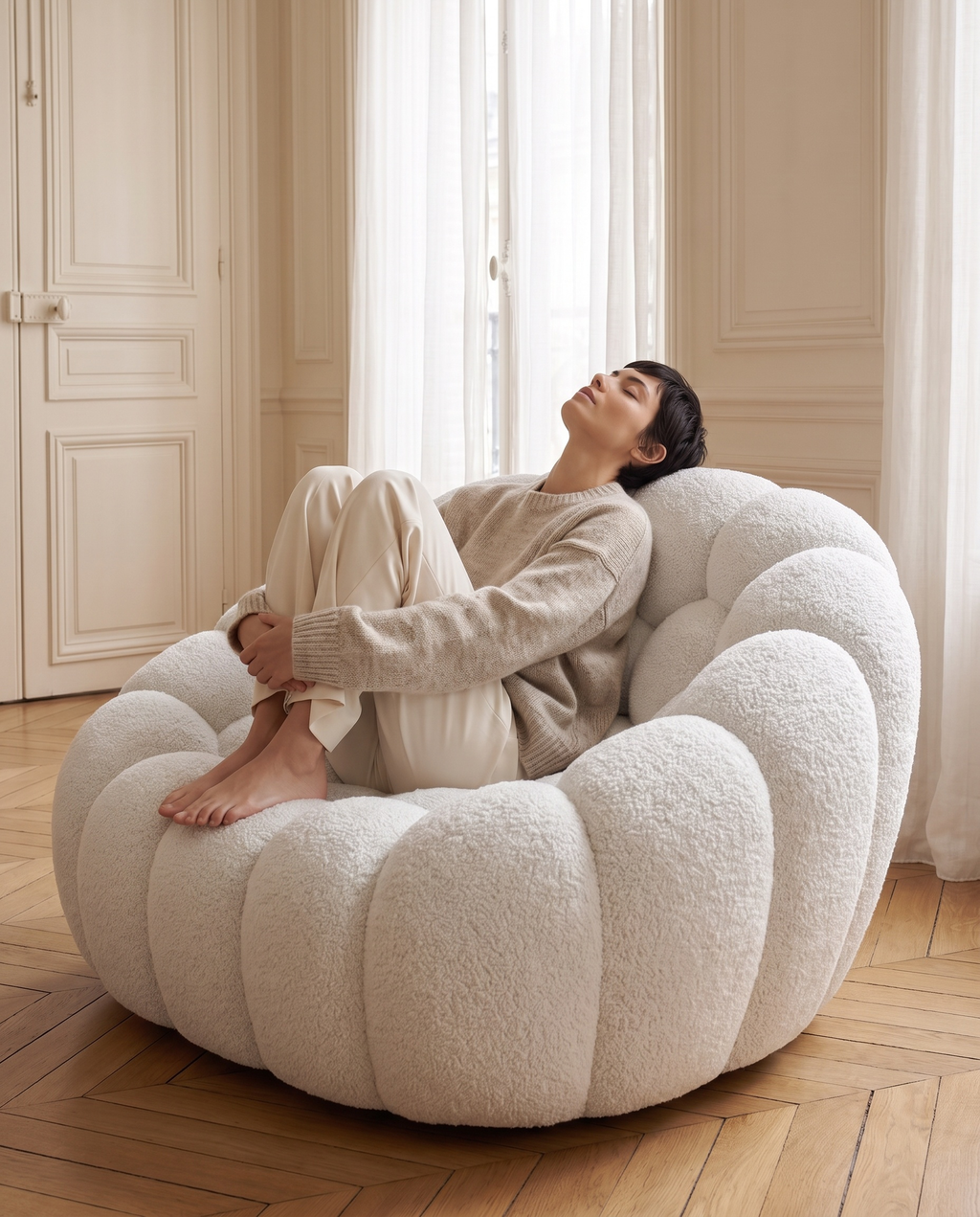 Woman curled up in the AP-89 1 seat armchair