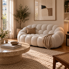 AP-89 2 seat sofa in Cloud White in a furnished Parisian living room, with rug, travertine table and a potted tree
