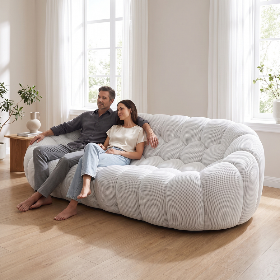 Couple relaxing on the AP-89 3 seat sofa in Cloud White, third seat still free